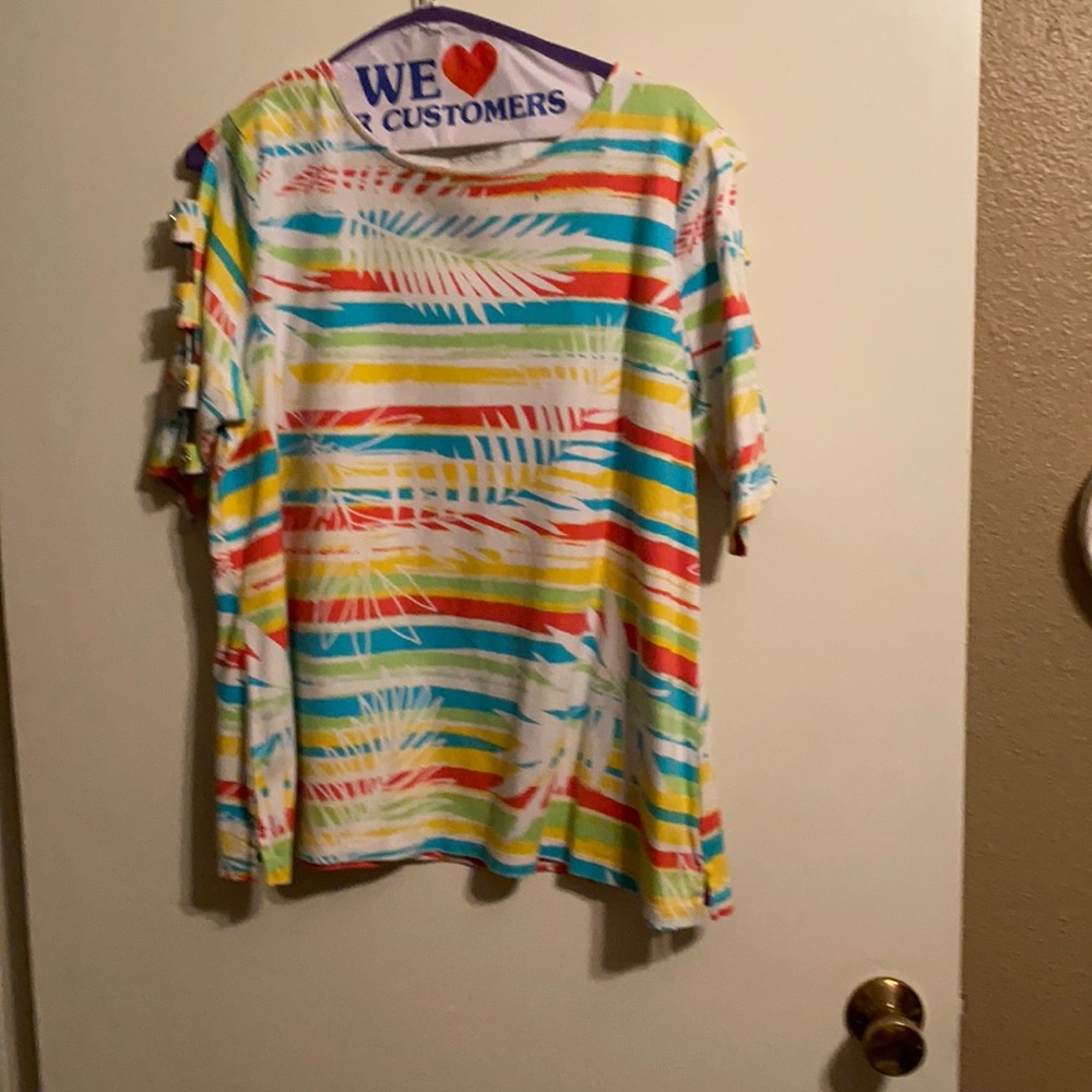 White blouse with cut outs in the sleeve.